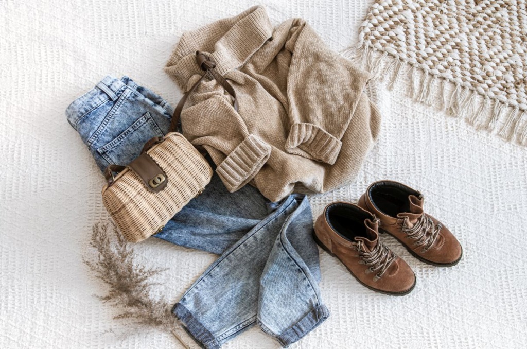 Set with fashionable women’s clothing jeans and a sweater .
