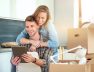 young-couple-moving-new-homesitting-relaxing-after-unpackinglooking-something-laptop-young-couple